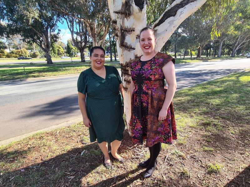 Two Ngunawal language facilitators standing in front of a tree