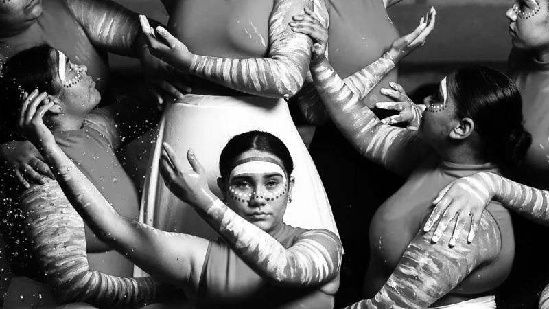 Black and white image of a group of First Nations dancers from the Brolga Dance Academy posing